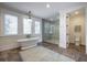 Bright bathroom featuring a soaking tub, walk-in shower, and modern fixtures at 3803 Palm Blvd, Isle of Palms, SC 29451