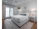 Bright bedroom with king size bed, white walls, and access to an outdoor balcony at 3803 Palm Blvd, Isle of Palms, SC 29451
