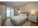 Cozy bedroom with a woven bed frame, access to a private balcony, and natural light at 3803 Palm Blvd, Isle of Palms, SC 29451