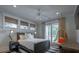 Bedroom featuring a hanging chair, windows, king size bed, and light colored walls at 3803 Palm Blvd, Isle of Palms, SC 29451