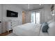 Bright bedroom featuring white walls, large bed, and access to a private balcony at 3803 Palm Blvd, Isle of Palms, SC 29451