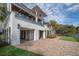Stylish three-story coastal home with a paved driveway and lush landscaping at 3803 Palm Blvd, Isle of Palms, SC 29451