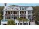Stunning multi-story home featuring spacious balconies, a rooftop deck and a refreshing in-ground pool at 3803 Palm Blvd, Isle of Palms, SC 29451
