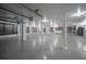 Spacious garage has a clean look with white walls and expansive speckled flooring at 3803 Palm Blvd, Isle of Palms, SC 29451