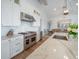 Modern kitchen with stainless steel appliances, marble countertops, and white cabinets, open to the dining area at 3803 Palm Blvd, Isle of Palms, SC 29451