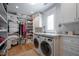 Well-organized laundry room with built-in shelving, counter space, and front-load washer/dryer at 3803 Palm Blvd, Isle of Palms, SC 29451