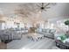 Open-concept living room featuring vaulted ceilings, exposed beams, and seamless flow to the kitchen and dining area at 3803 Palm Blvd, Isle of Palms, SC 29451