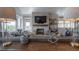 Bright living room showcasing a stone fireplace, large windows, hardwood floors, and comfortable, stylish decor at 3803 Palm Blvd, Isle of Palms, SC 29451