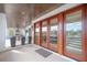 Covered patio featuring wood ceilings, tile flooring, French doors, and comfortable seating area at 3803 Palm Blvd, Isle of Palms, SC 29451