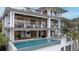 Stunning three-story home featuring a private pool, multiple balconies, and beautiful architectural details at 3803 Palm Blvd, Isle of Palms, SC 29451