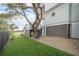 Well-manicured yard with lush grass, and coastal-style home with ground-level storage at 3803 Palm Blvd, Isle of Palms, SC 29451