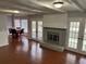 Spacious living room with brick fireplace, beamed ceiling and glass doors to the exterior at 4 Fairway Ct, Walterboro, SC 29488