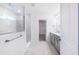 Modern bathroom with walk-in shower, double vanity, and access to the walk-in closet at 409 Cadbury Loop, Summerville, SC 29486