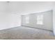 Bright bedroom with plush carpet and two large windows offering ample natural light at 409 Cadbury Loop, Summerville, SC 29486