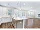 Open-concept kitchen with gray island, white subway tile backsplash, and lots of natural light at 409 Cadbury Loop, Summerville, SC 29486