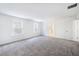 Large primary bedroom with plush carpet, two windows, and an en-suite bathroom at 409 Cadbury Loop, Summerville, SC 29486