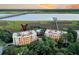 Aerial view of condos, pool, and waterway with a bridge in the background. Luxury coastal living at 4247 Faber Place Dr # 5103, North Charleston, SC 29405