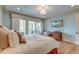Relaxing bedroom featuring a spacious bed, wooden floor, and balcony access at 4247 Faber Place Dr # 5103, North Charleston, SC 29405