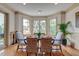 Elegant dining room with natural light from bay windows and stylish seating for a cozy atmosphere at 4247 Faber Place Dr # 5103, North Charleston, SC 29405