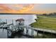 A wooden dock with a covered gazebo extends into the water at sunset, offering scenic waterfront views at 4247 Faber Place Dr # 5103, North Charleston, SC 29405