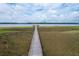 Aerial view of a long wooden dock leading out into a tranquil body of water at 4247 Faber Place Dr # 5103, North Charleston, SC 29405