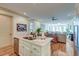 Modern kitchen island with stainless steel appliances and hardwood floors open to living area at 4247 Faber Place Dr # 5103, North Charleston, SC 29405
