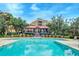 Exterior view of a resort-style community pool with a building and lounge chairs at 4247 Faber Place Dr # 5103, North Charleston, SC 29405