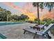 Community pool with lounge chairs and a fire pit area overlooking a sunset view at 4247 Faber Place Dr # 5103, North Charleston, SC 29405