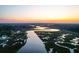 Picturesque aerial view of the waterfront property at sunset with community dock at 4281 Jacobs Point Ct, Ravenel, SC 29470