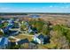 Aerial view of a waterside neighborhood featuring diverse home styles and tranquil water views at 4281 Jacobs Point Ct, Ravenel, SC 29470