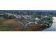 Aerial view of waterfront community with marshland and a dock at 4281 Jacobs Point Ct, Ravenel, SC 29470
