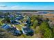Aerial view of a waterside neighborhood featuring diverse home styles and mature trees at 4281 Jacobs Point Ct, Ravenel, SC 29470