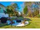 Inviting backyard featuring a fire pit with Adirondack chairs and a grill, perfect for outdoor relaxation and entertaining at 4281 Jacobs Point Ct, Ravenel, SC 29470