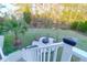 Backyard featuring seating area with fire pit, lush lawn, and mature trees at 4281 Jacobs Point Ct, Ravenel, SC 29470