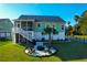 Aerial view of backyard with a fire pit area, a grill, mature trees, screened porch, and a fenced perimeter at 4281 Jacobs Point Ct, Ravenel, SC 29470