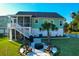 Aerial view of backyard with a cozy fire pit area, grill, mature trees, and a fenced perimeter, great for privacy at 4281 Jacobs Point Ct, Ravenel, SC 29470