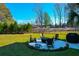 Spacious backyard showcasing a fire pit with Adirondack chairs, offering a cozy outdoor gathering space at 4281 Jacobs Point Ct, Ravenel, SC 29470
