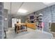 Spacious basement with a functional workspace, storage shelving, and vintage refrigerator at 4281 Jacobs Point Ct, Ravenel, SC 29470