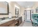 Well-lit bathroom with dual sink vanity, mosaic mirrors, a separate shower and tile floors at 4281 Jacobs Point Ct, Ravenel, SC 29470