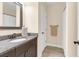 Bathroom with a single vanity with granite countertop, dark wood cabinets, and updated fixtures at 4281 Jacobs Point Ct, Ravenel, SC 29470