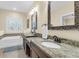 Bright bathroom features a double vanity with granite countertops and a soaking tub at 4281 Jacobs Point Ct, Ravenel, SC 29470