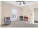 Comfortable bedroom with natural light, plantation shutters, and cozy seating area at 4281 Jacobs Point Ct, Ravenel, SC 29470