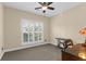 A neutral-toned bedroom features a ceiling fan, shuttered windows, and carpeted floors at 4281 Jacobs Point Ct, Ravenel, SC 29470