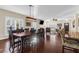 Open-concept dining room, with hardwood floors, flowing into the living room and featuring a contemporary light fixture at 4281 Jacobs Point Ct, Ravenel, SC 29470