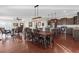 Open concept dining area connecting living room and kitchen, with wood floors and modern lighting fixtures at 4281 Jacobs Point Ct, Ravenel, SC 29470