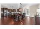 Beautiful dining area with wood floors, pendant lighting, stainless steel appliances, and access to the patio at 4281 Jacobs Point Ct, Ravenel, SC 29470