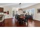 Dining room features hardwood floors, natural light, and a table with seating for eight at 4281 Jacobs Point Ct, Ravenel, SC 29470