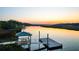 Waterfront view of the covered dock and boardwalk at sunset at 4281 Jacobs Point Ct, Ravenel, SC 29470