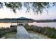 Charming gazebo-covered dock extending into the serene waters, surrounded by lush marshland and tranquil scenery at 4281 Jacobs Point Ct, Ravenel, SC 29470