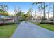 Welcoming community entrance marked by brick signage and landscaped greenery, establishing a serene neighborhood at 4281 Jacobs Point Ct, Ravenel, SC 29470